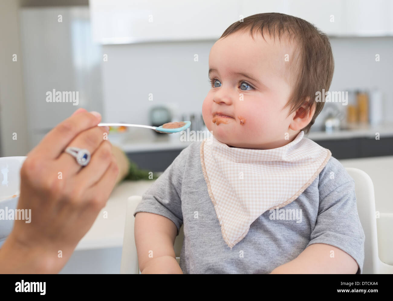 Innocent baby being fed by mother Stock Photo