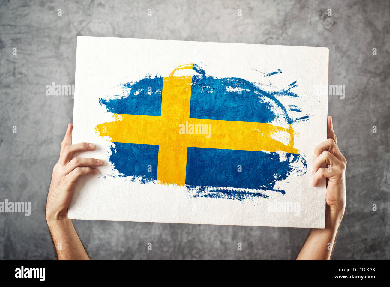 Sweden flag. Man holding banner with Swedish Flag. Supporting national team, patriotism concept. Stock Photo