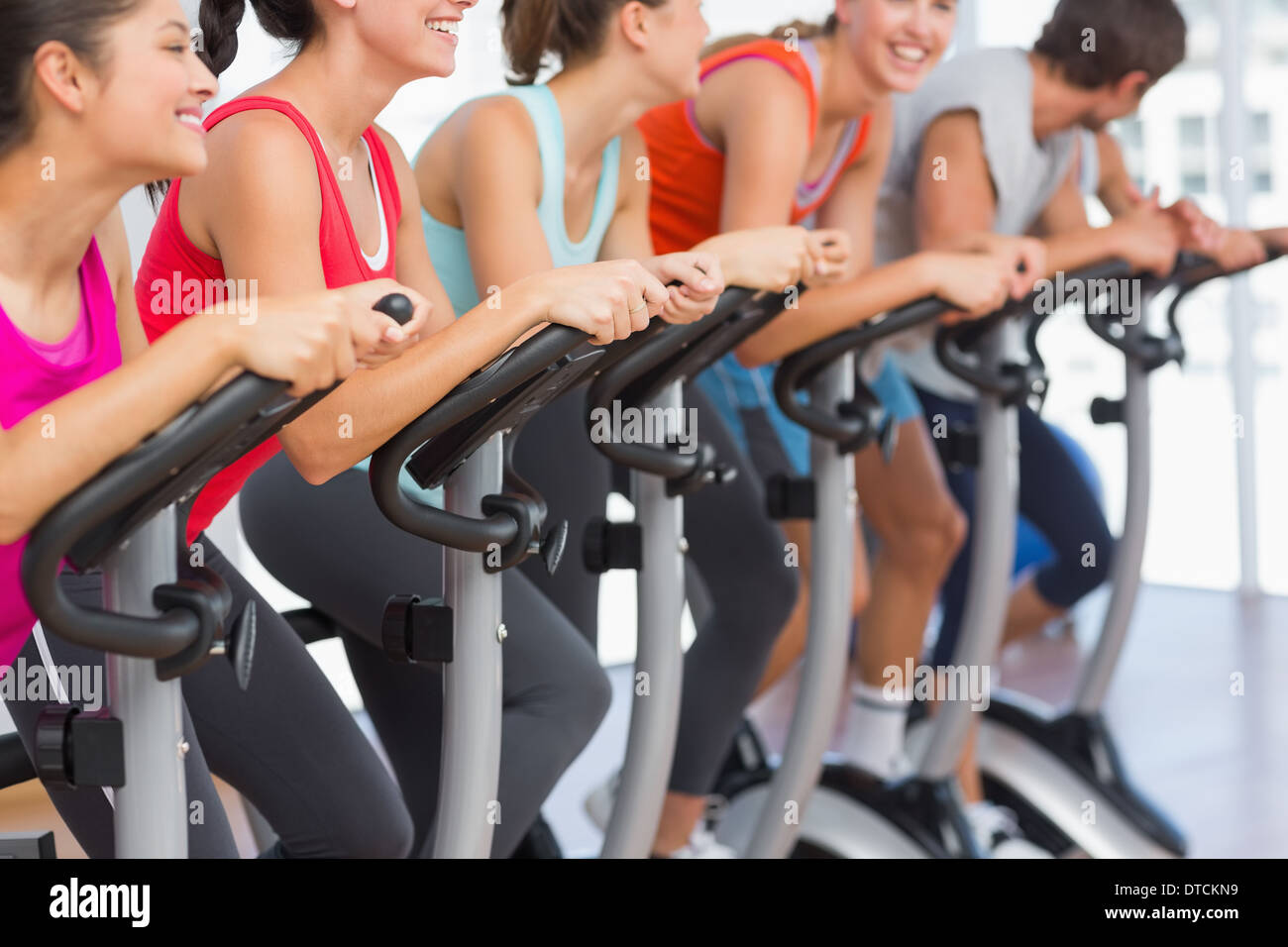 Fit people working out at spinning class Stock Photo - Alamy