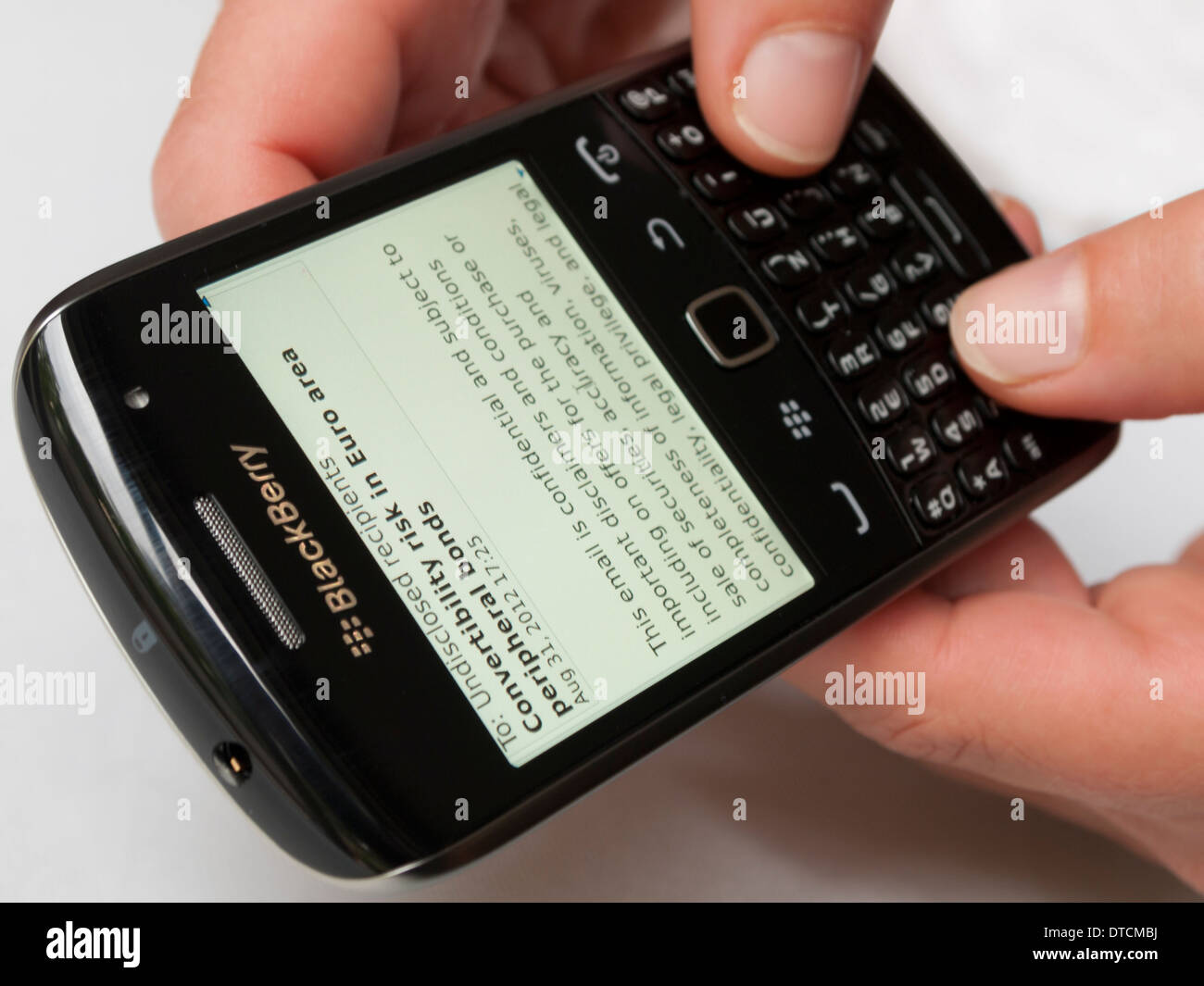 Fingers typing on RIM Blackberry handheld smartphone Stock Photo