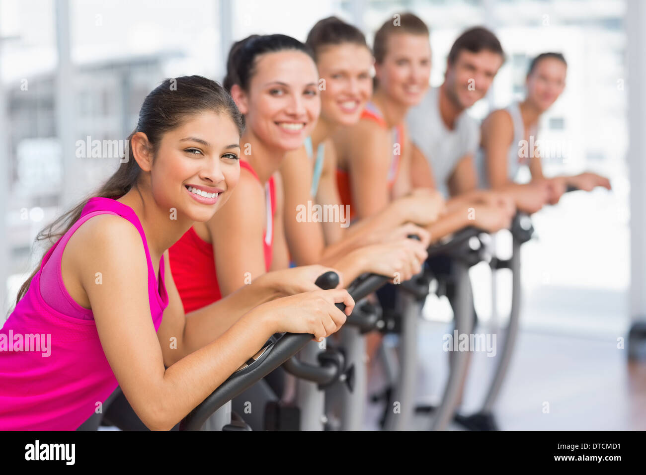 Fit young people working out at spinning class Stock Photo - Alamy