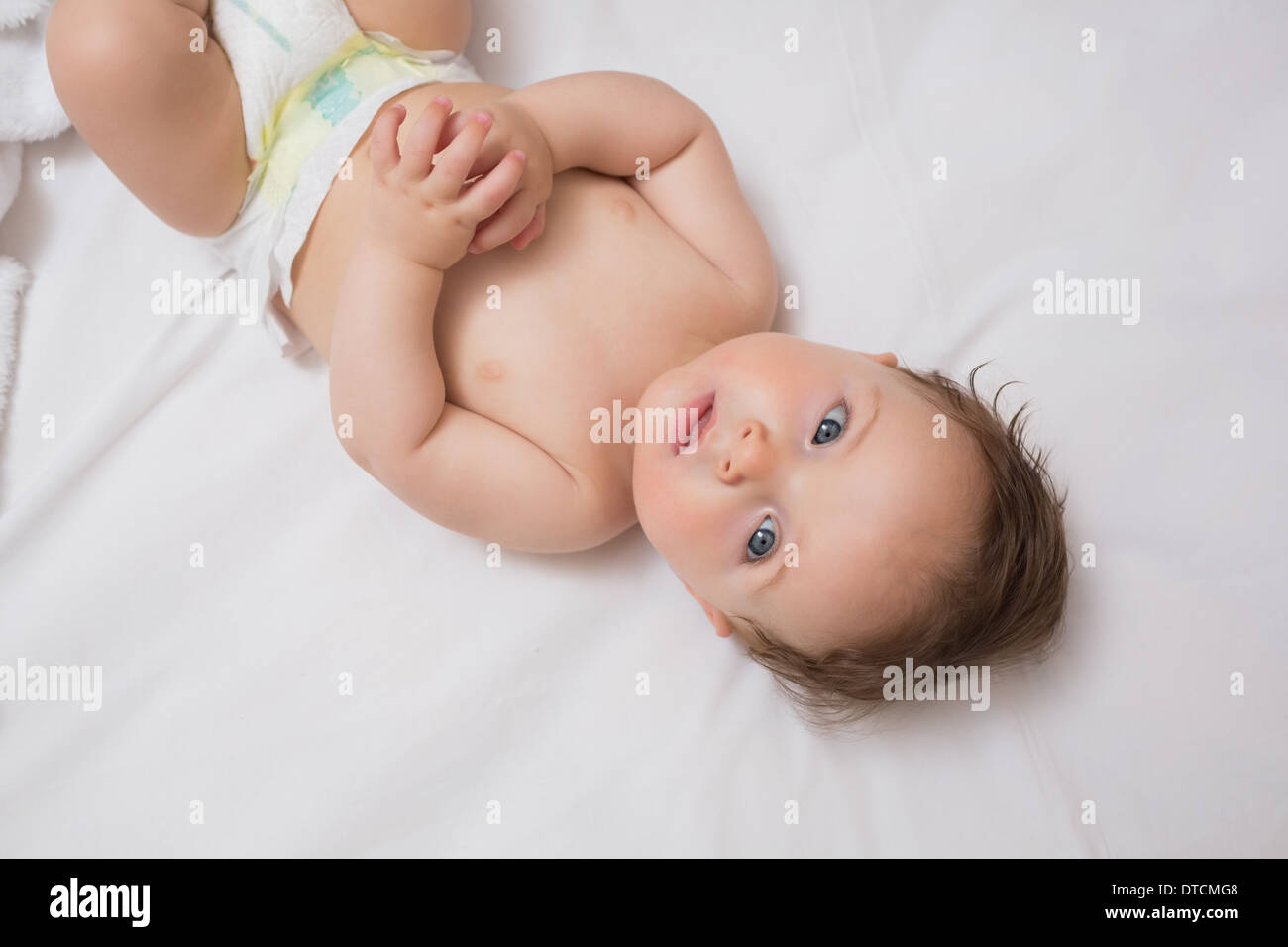 Innocent baby lying in crib Stock Photo