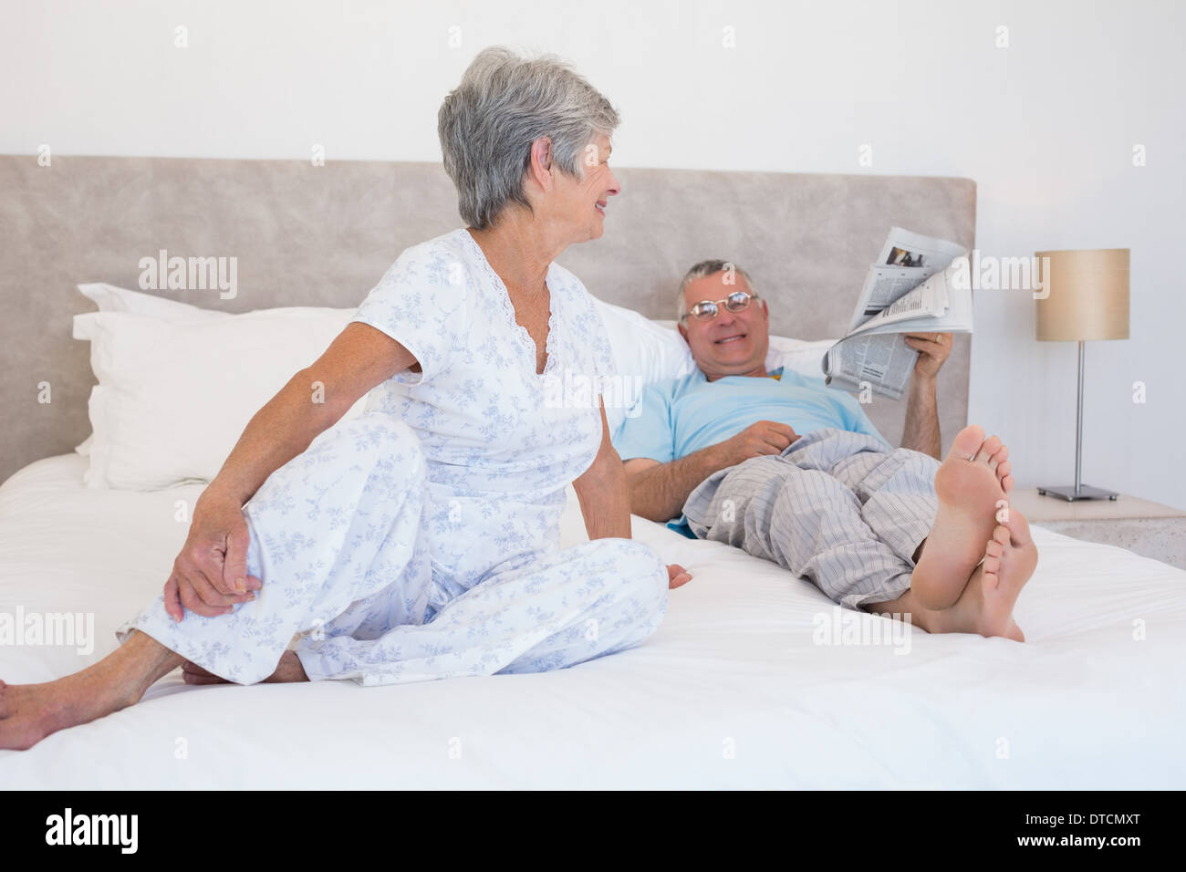 Senior couple relaxing in bed Stock Photo