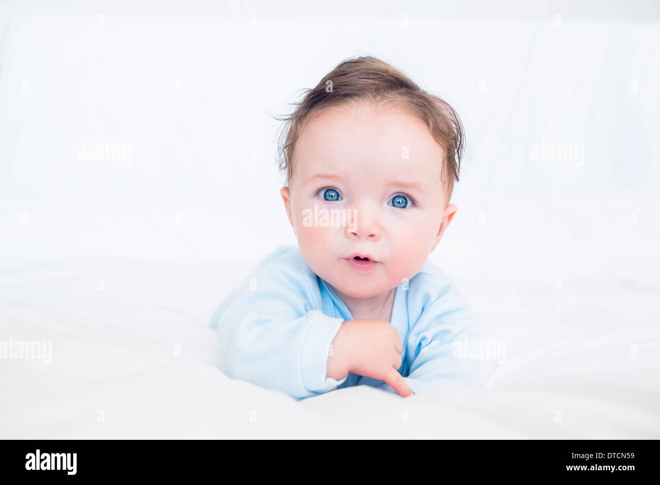 Innocent baby with blue eyes Stock Photo