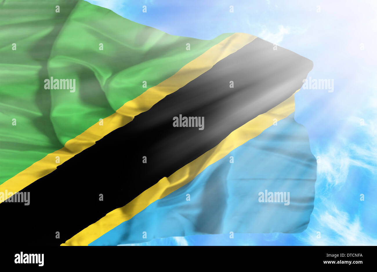 Tanzania waving flag against blue sky with sunrays Stock Photo - Alamy