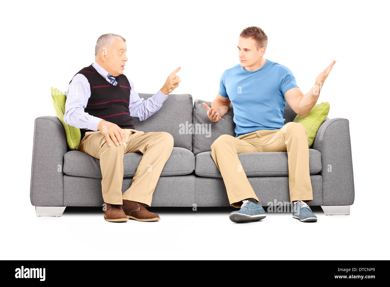 Two men arguing seated on a sofa Stock Photo Alamy