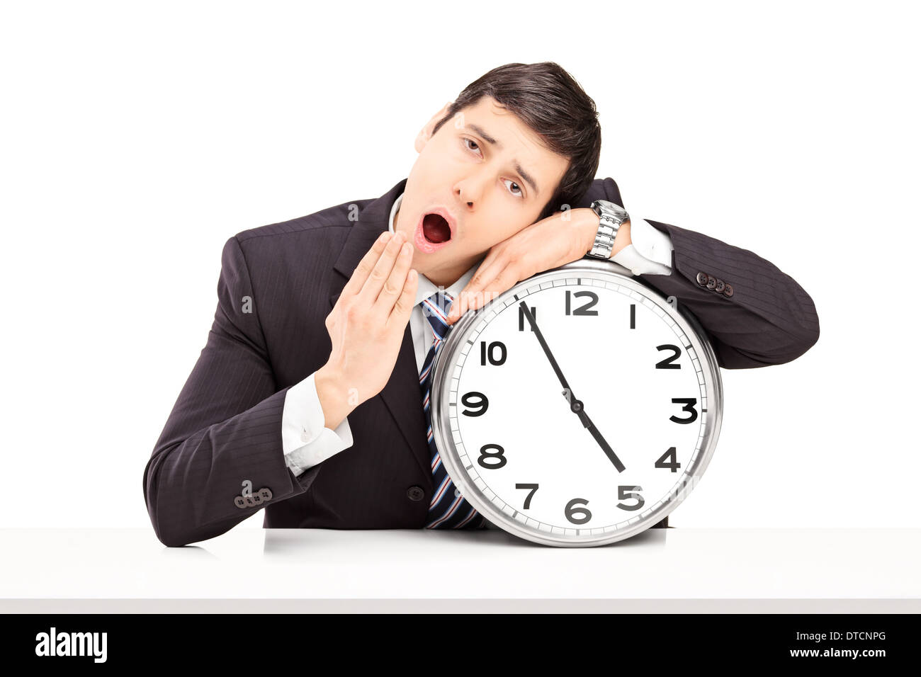 Young businessman falling asleep on a big wall clock Stock Photo Alamy