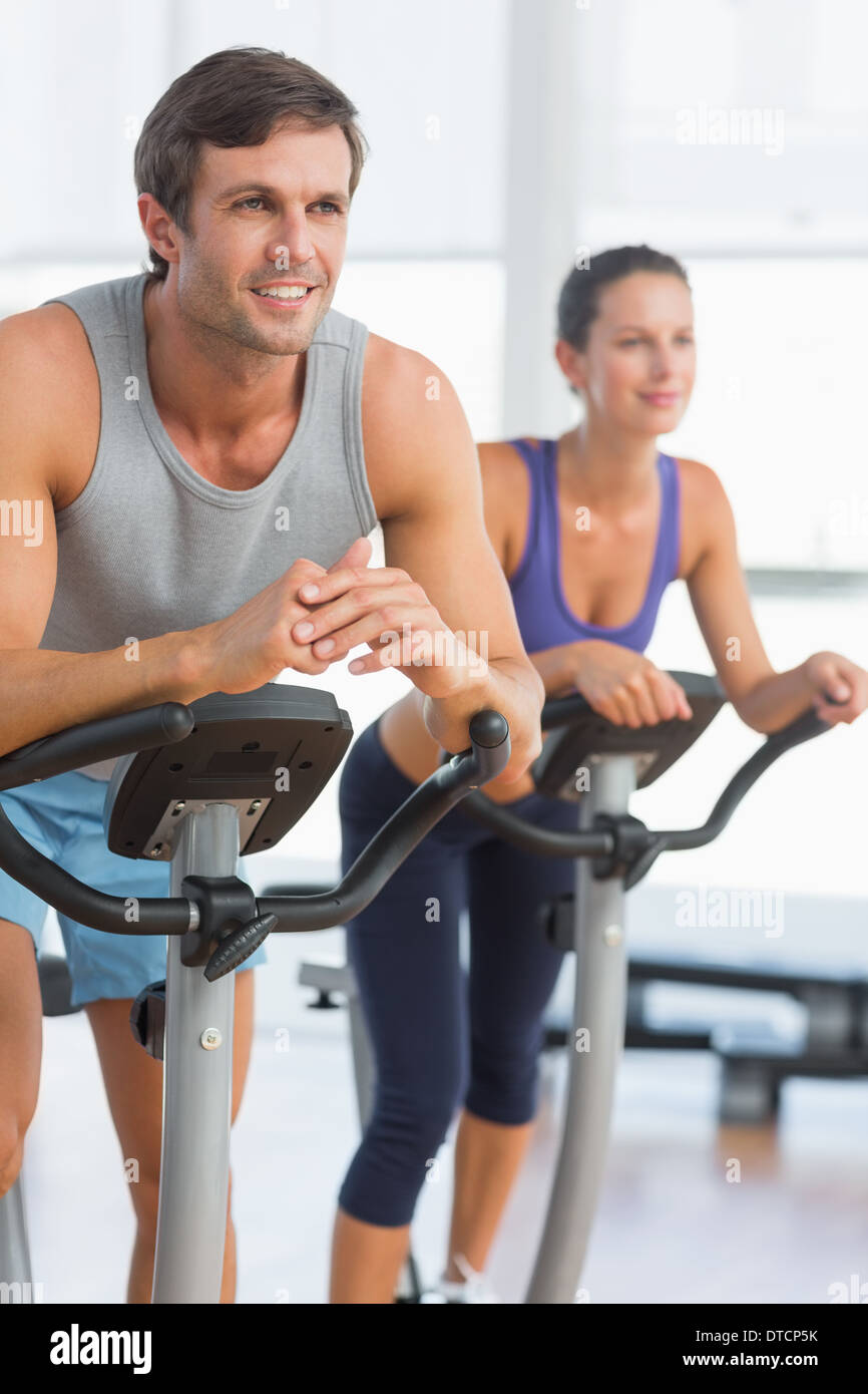 Smiling young couple working out at spinning class Stock Photo - Alamy