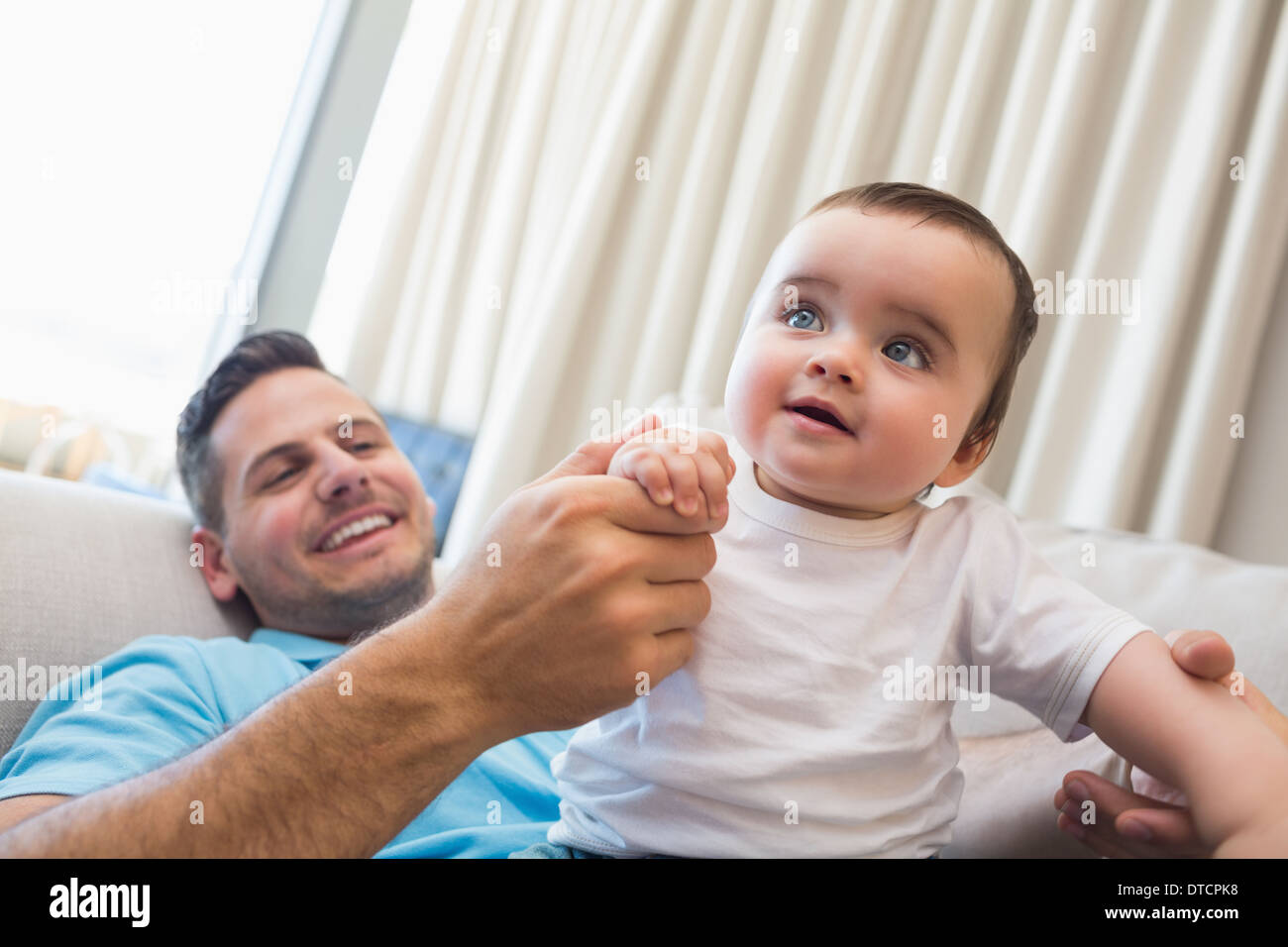 Happy father with baby at home Stock Photo