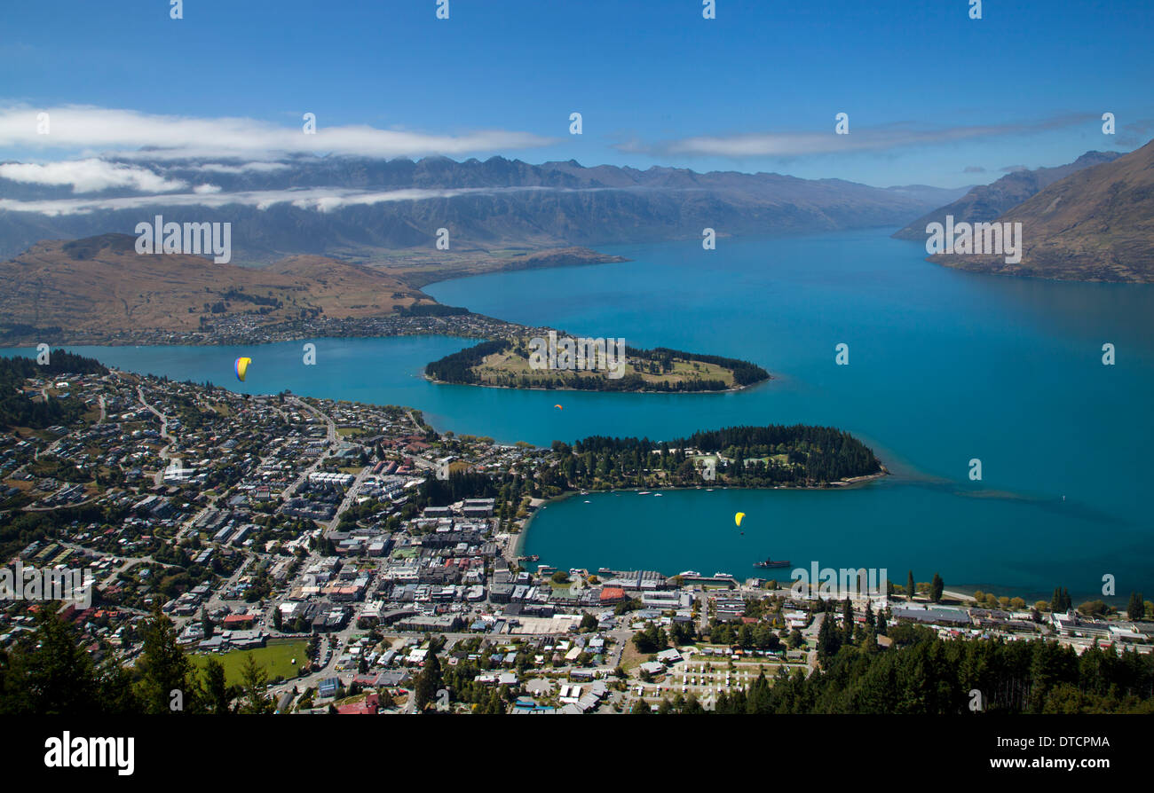 View over Queenstown and Lake Wakatipu, with paragliders, South Island, New Zealand Stock Photo