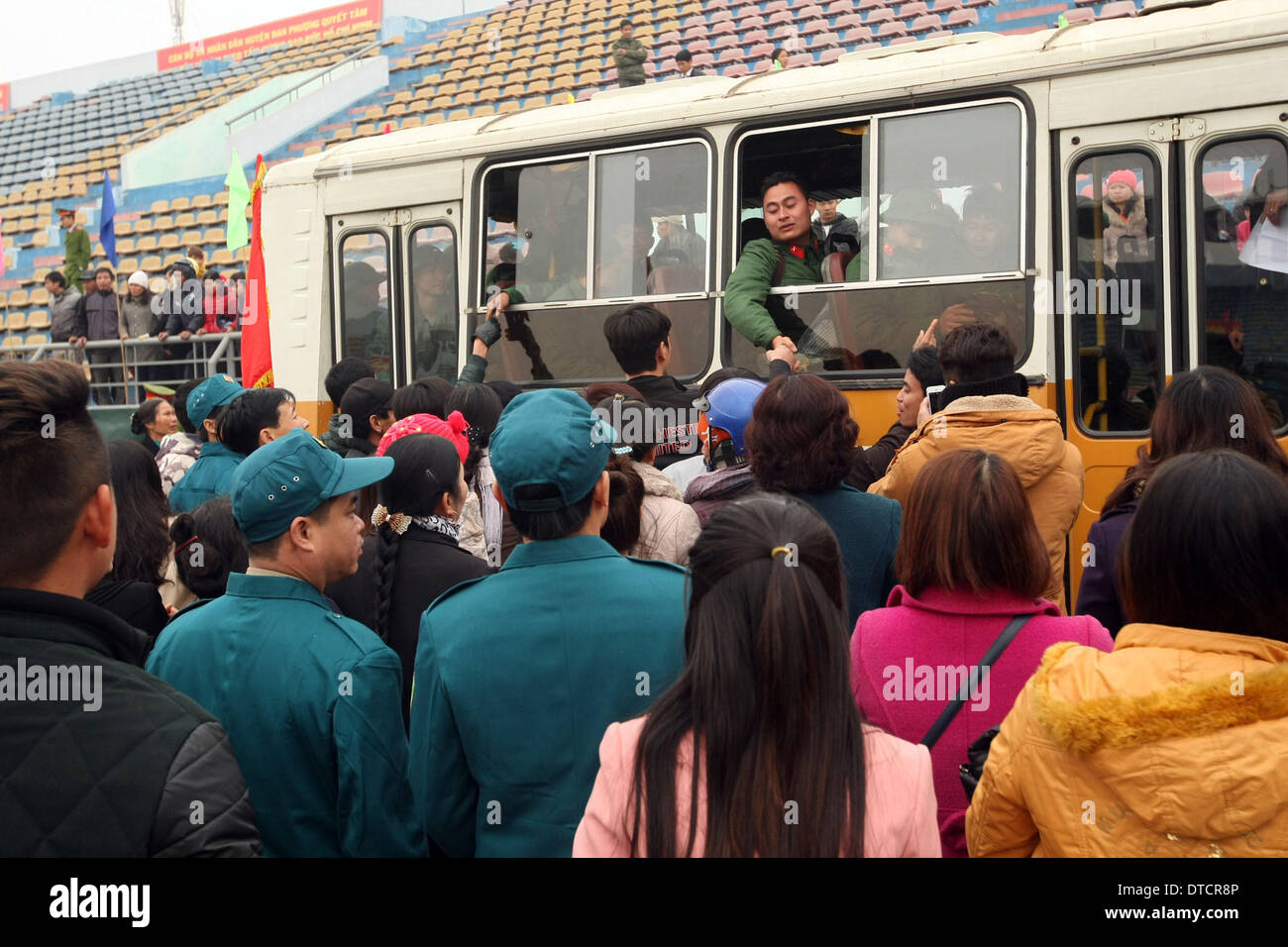 Hanoi, Vietnam. 15th Feb, 2014. Recruits bid goodbye to relatives and friends during recruitment at Dan Phuong District in Hanoi, capital of Vietnam, on Feb. 15, 2014. Nearly 2,000 young people were recruited in Hanoi in the first recruitment of 2014. Vietnam holds army recruitment twice a year. Credit:  VNA/Xinhua/Alamy Live News Stock Photo