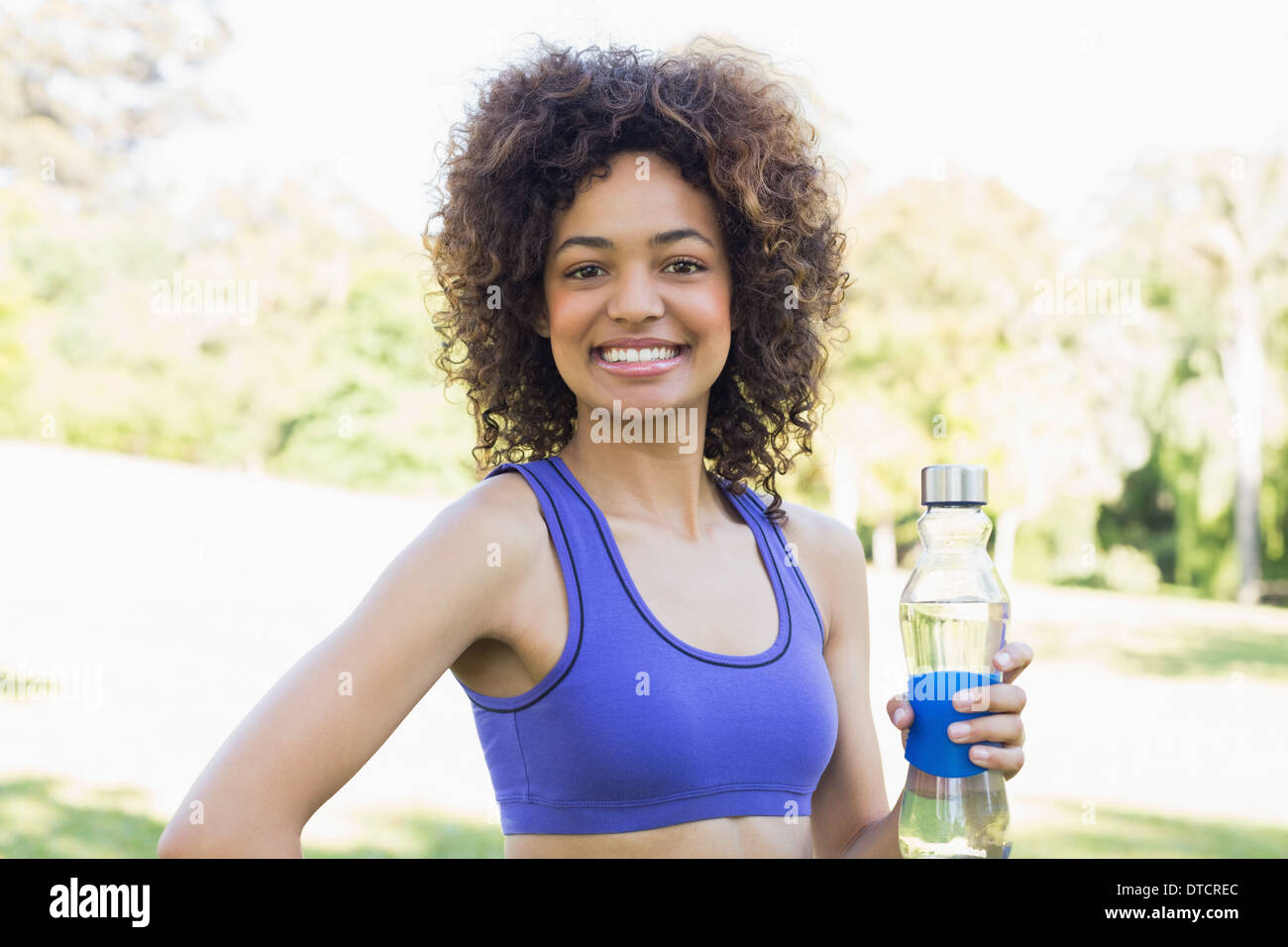 Happy fit woman holding water bottle Stock Photo - Alamy