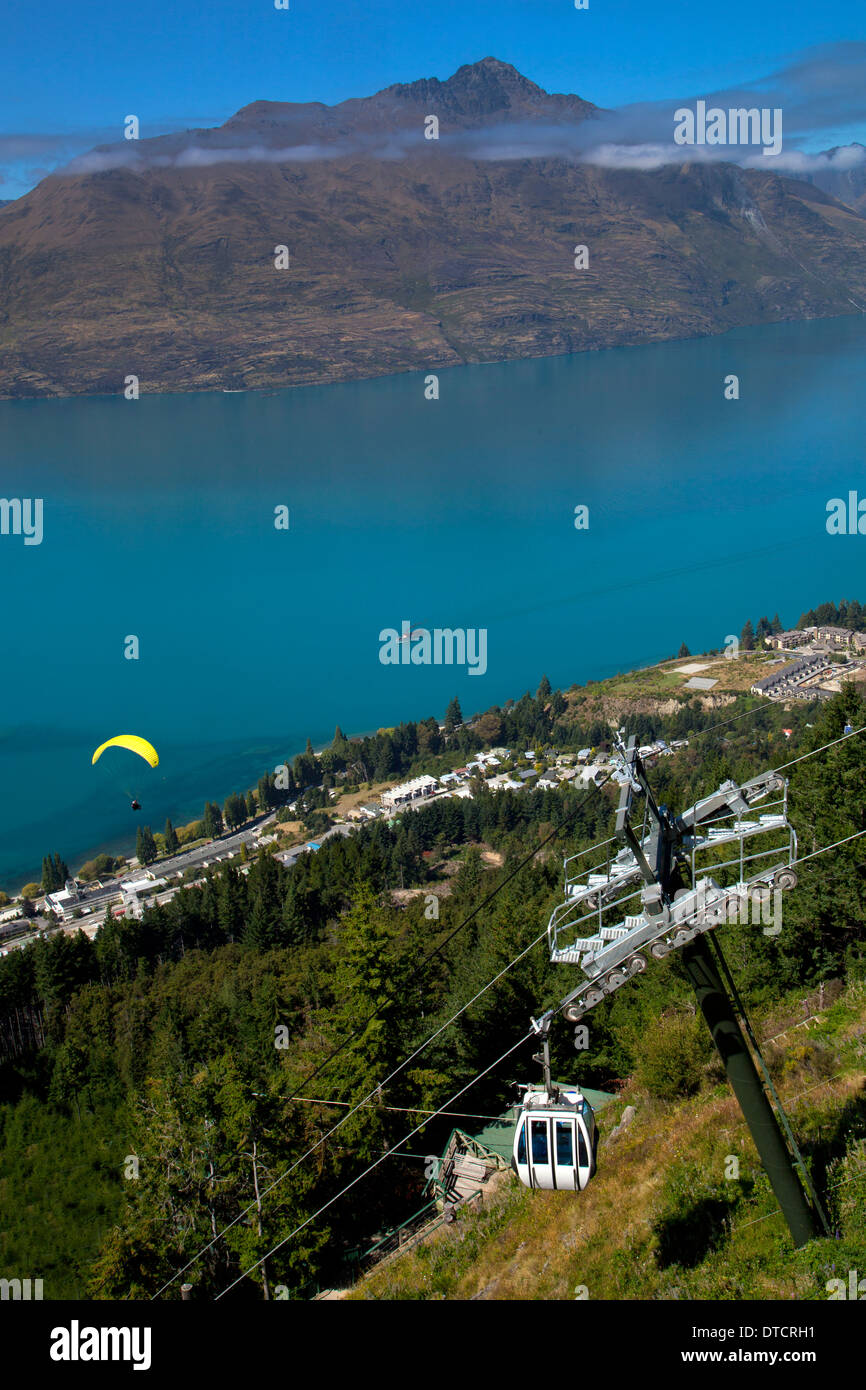 View over Queenstown and Lake Wakatipu, with paraglider and chairlift, South Island, New Zealand Stock Photo