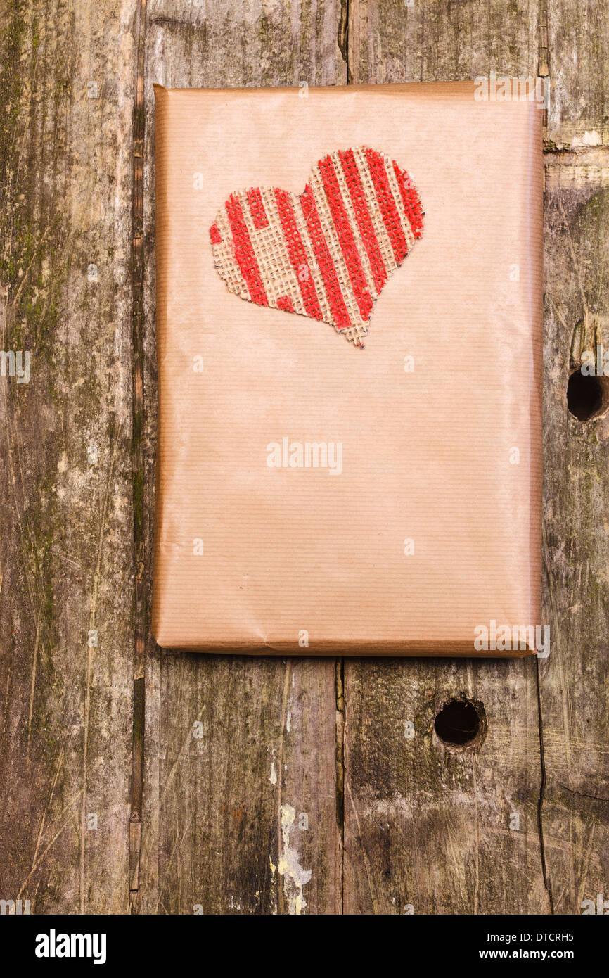 Wooden background with a hammered heart Stock Photo