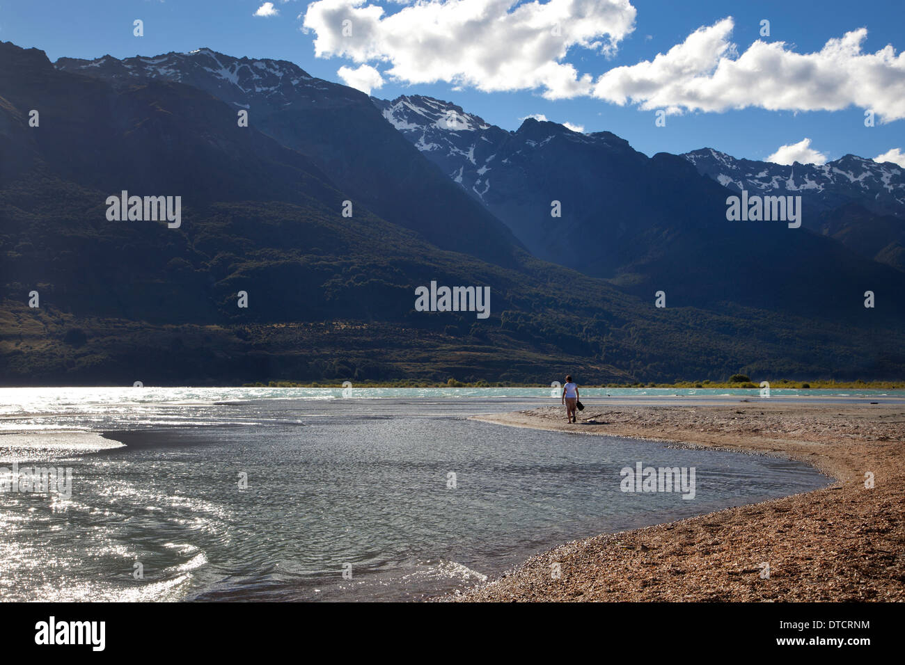 Woman walking along shore at Lake wakatipu, Glenorchy, South Island, New Zealand Stock Photo