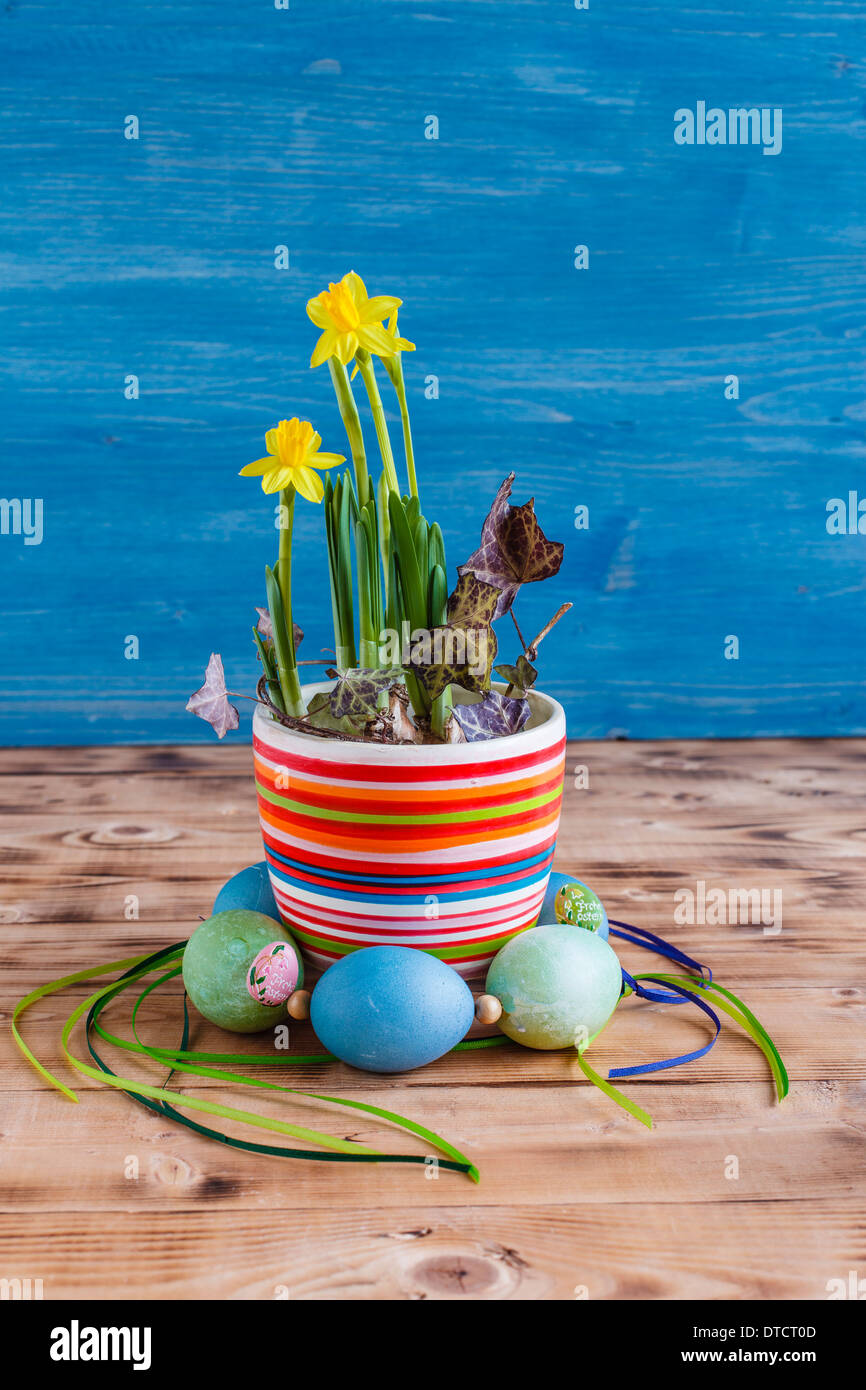 Daffodils in pot with wreath from Easter eggs, Easter decorations Stock Photo