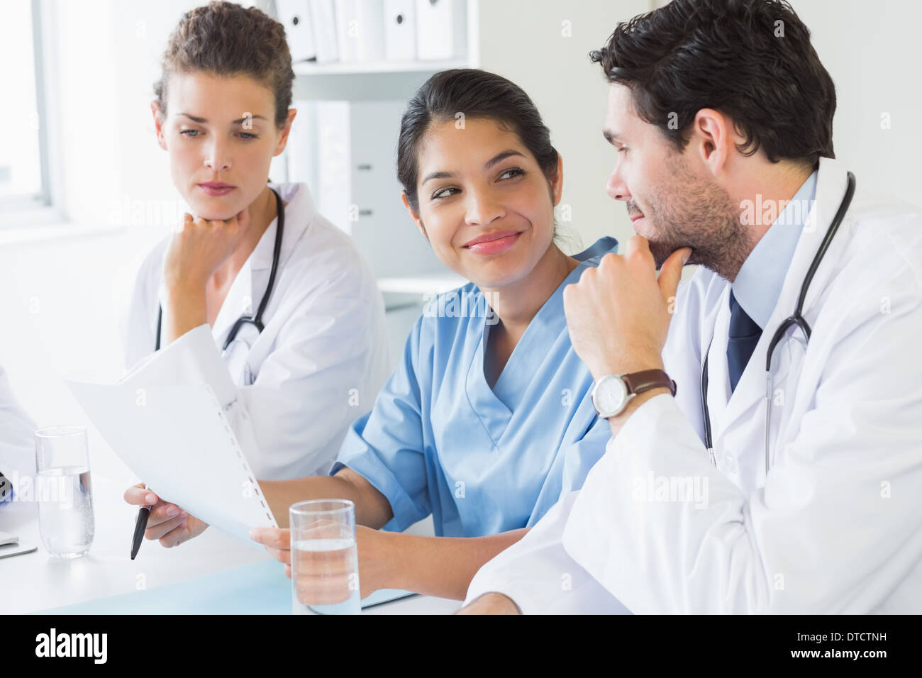 Nurse sitting on doctors desk hi-res stock photography and images - Alamy