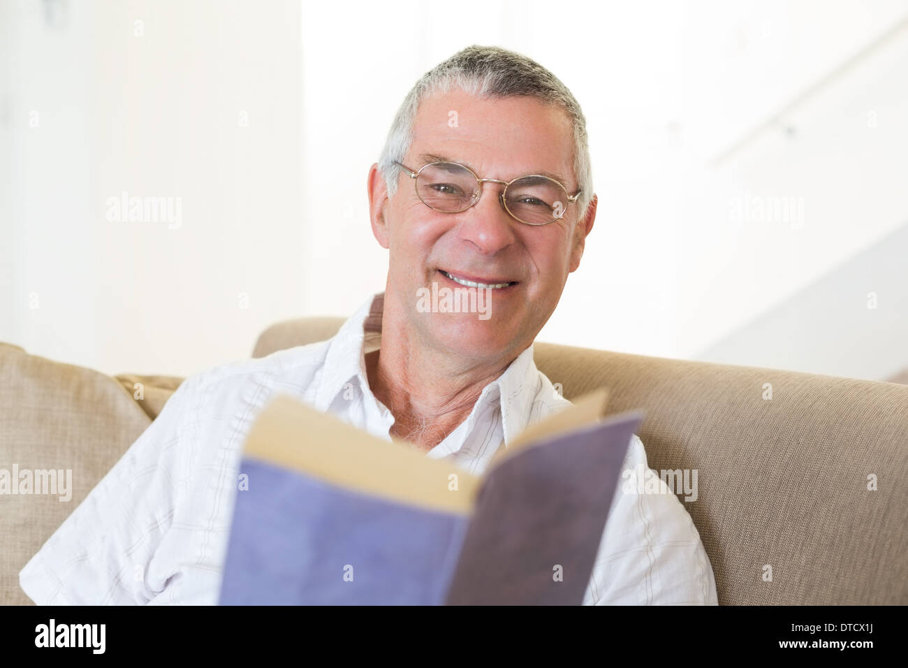 Handsome senior man sitting hi-res stock photography and images - Alamy