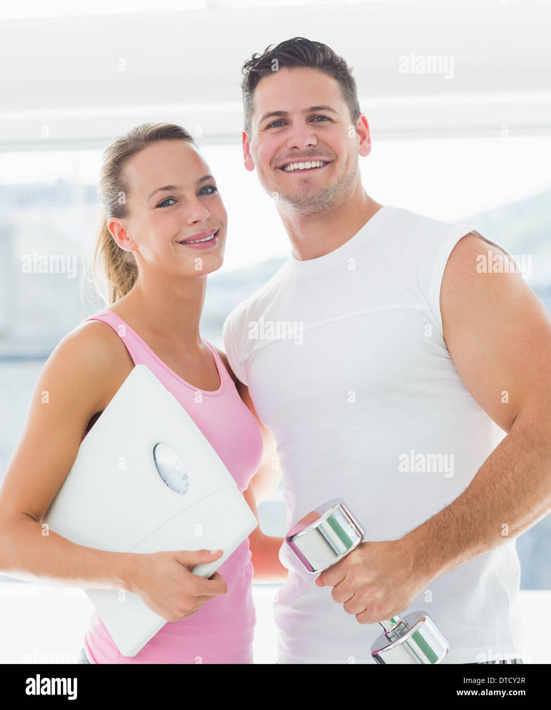 Woman hugging weight scale hi-res stock photography and images - Alamy