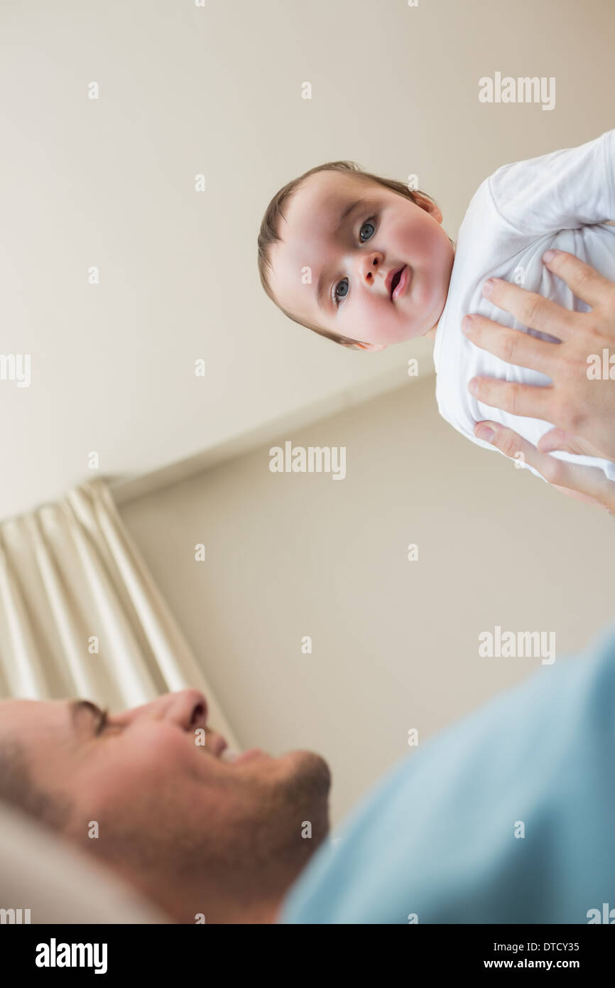 Baby being carried by father Stock Photo