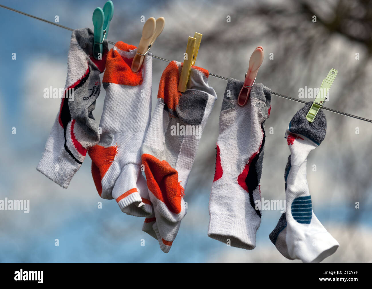 socks hanging out to dry on linen line Stock Photo Alamy