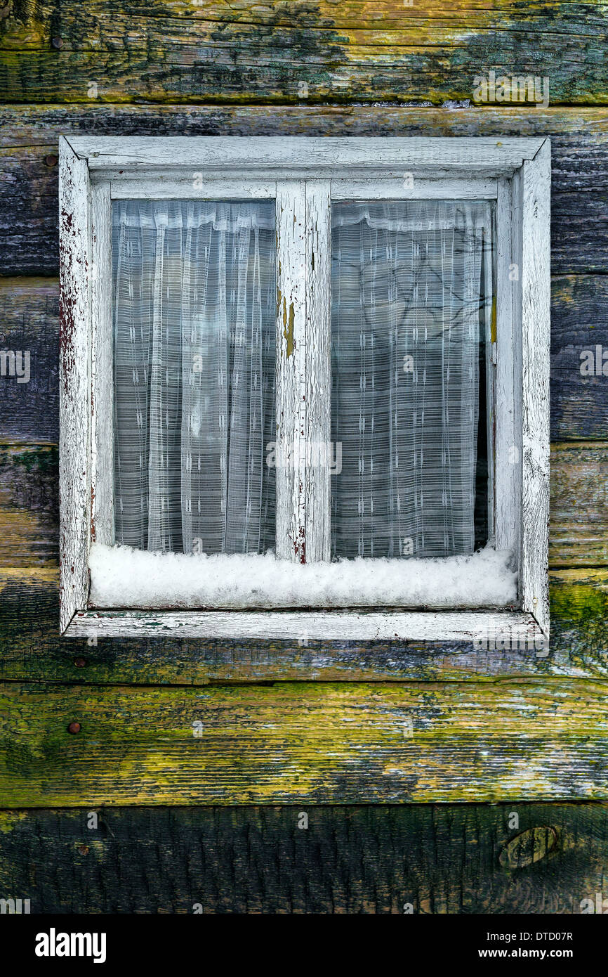 Shabby window on a wooden background in winter Stock Photo