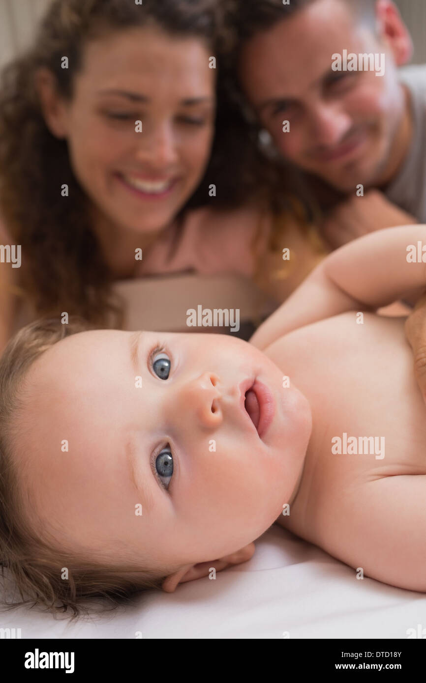 Cute baby with parents in background Stock Photo
