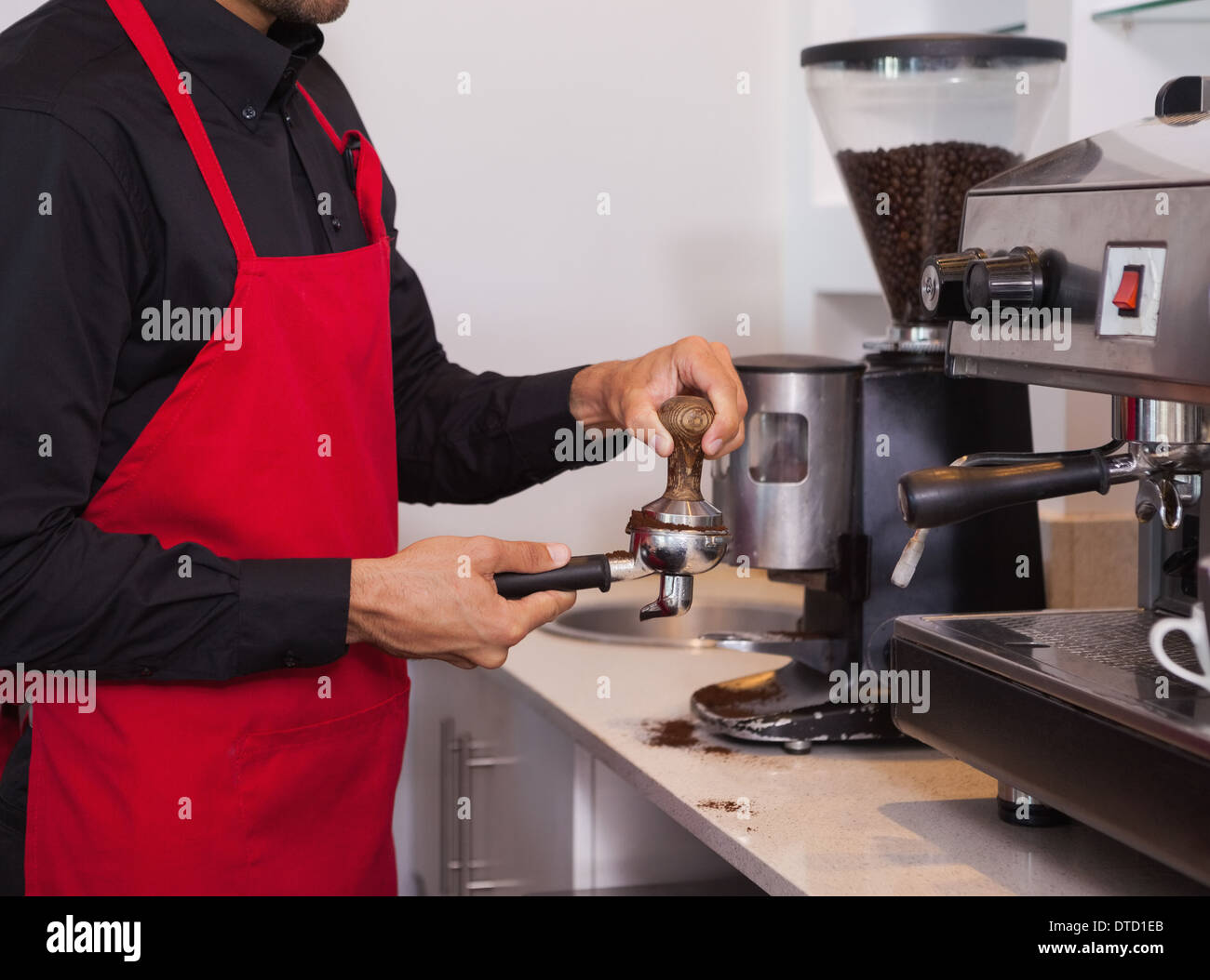 Barista pressing the coffee grounds Stock Photo Alamy