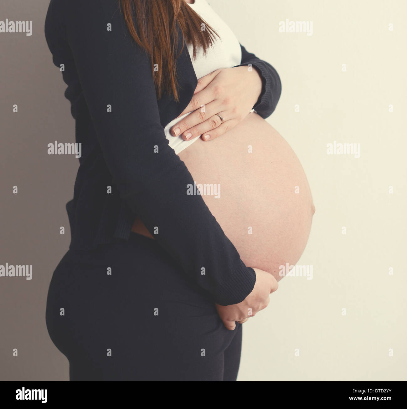 Pregnant woman holding belly with hands Stock Photo Alamy