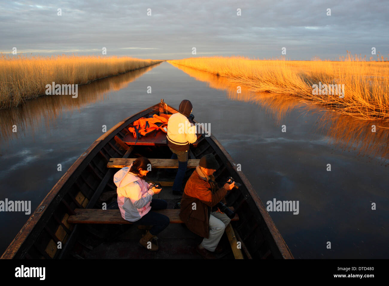 Photographers taking a boat trip on Kasari river, Matsalu National Park, Estonia Stock Photo