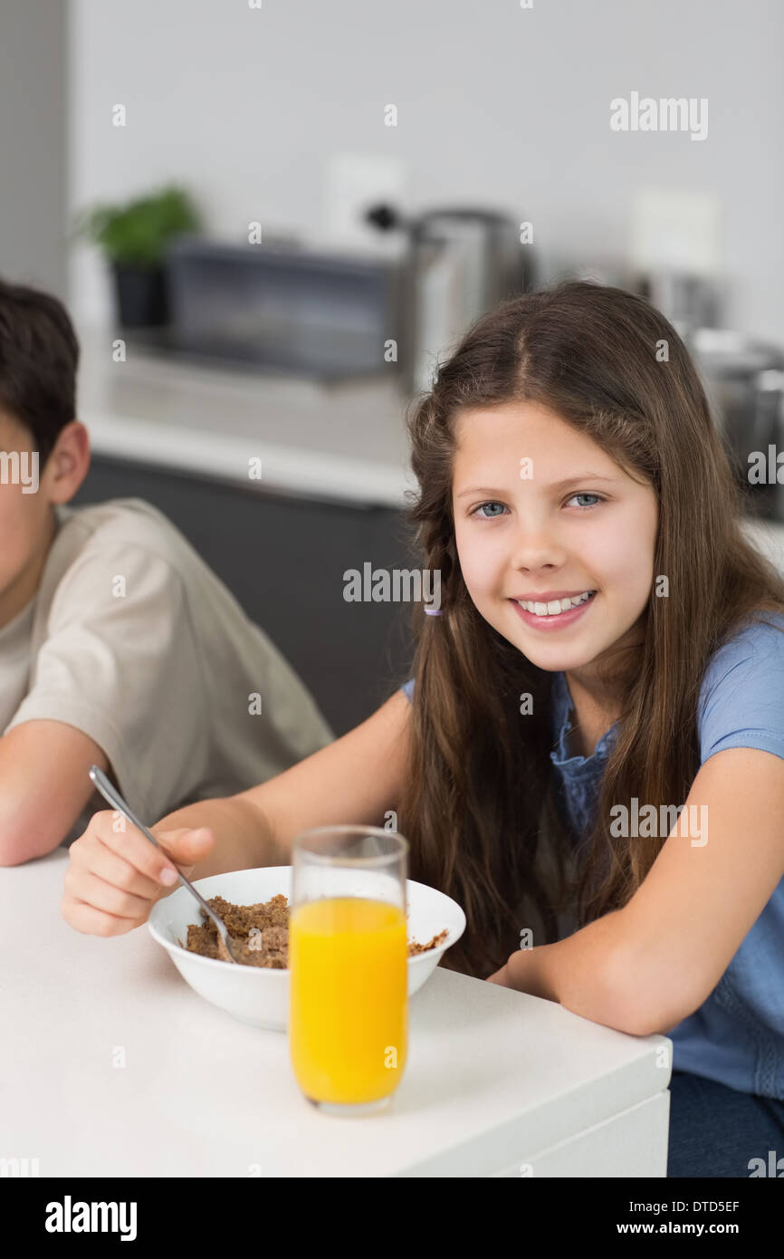 Portrait of two smiling siblings enjoying breakfast Stock Photo - Alamy