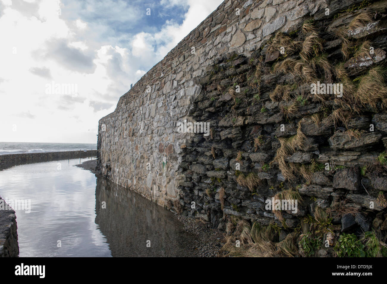 Porthleven, Cornwall, UK. 15th Feb, 2014. Huge swathes of mortar have been washed out of this wall at Porthleven Credit:  Bob Sharples/Alamy Live News Stock Photo