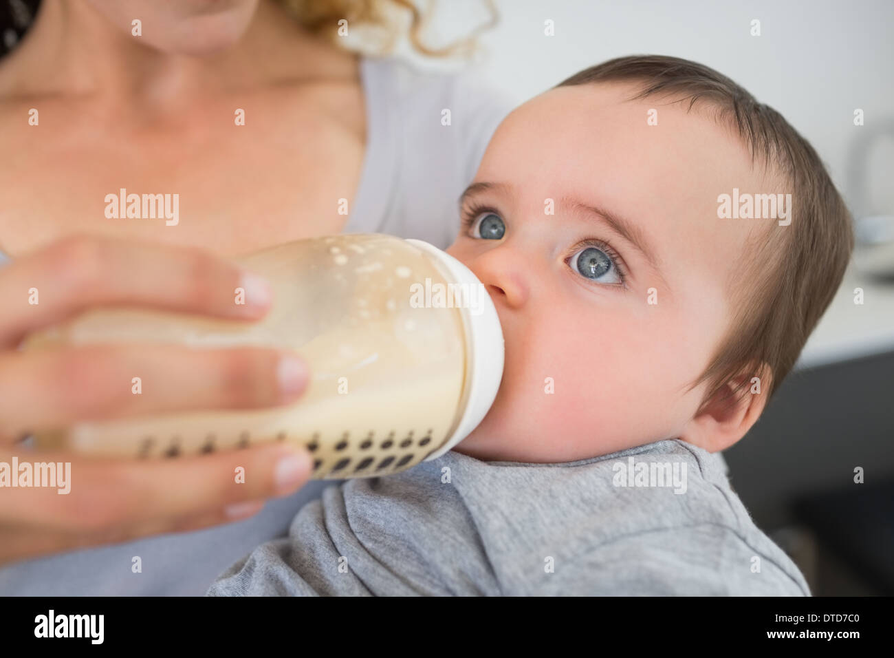 Mother feeding milk to baby Stock Photo