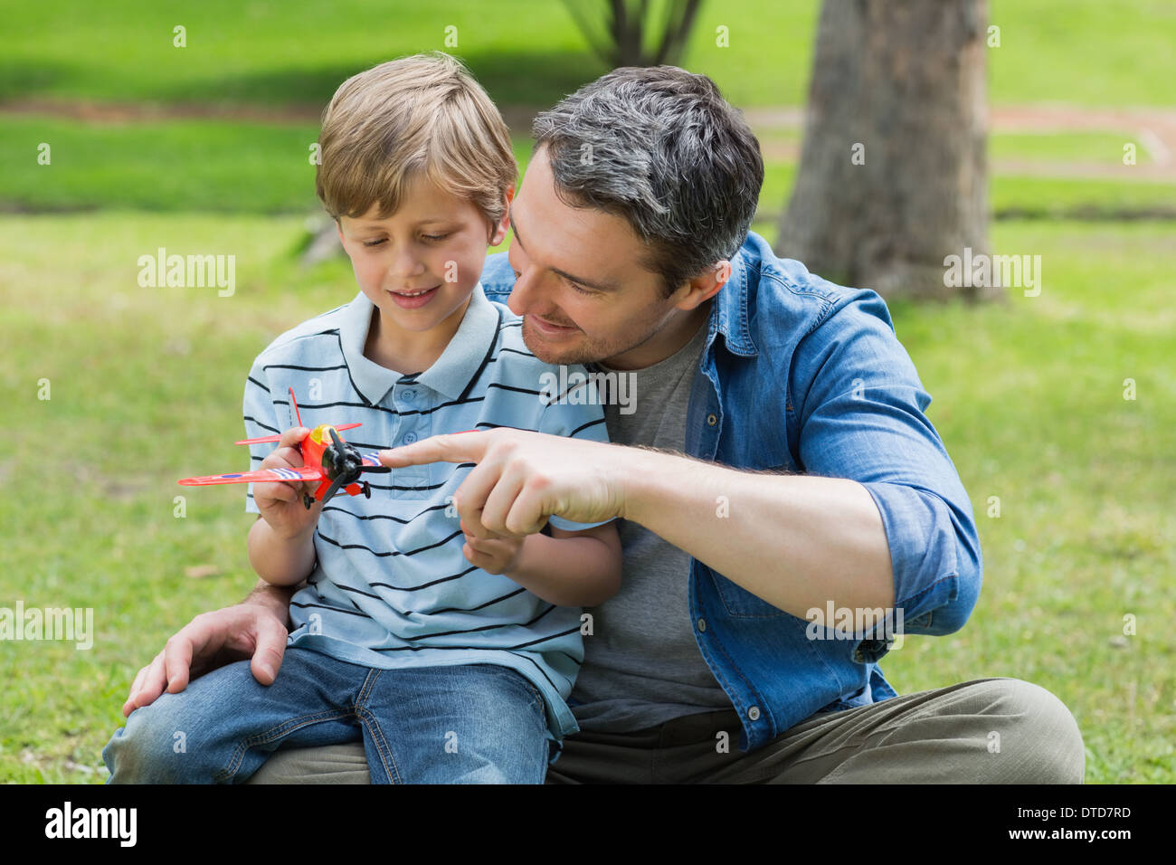 Boy sitting on fathers lap hi-res stock photography and images - Alamy