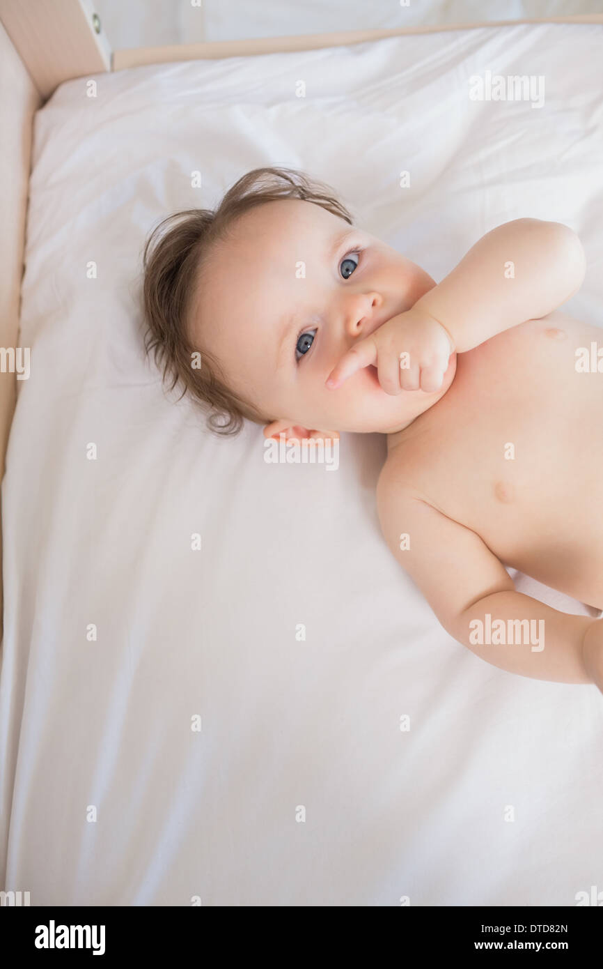 Baby boy with finger in mouth Stock Photo