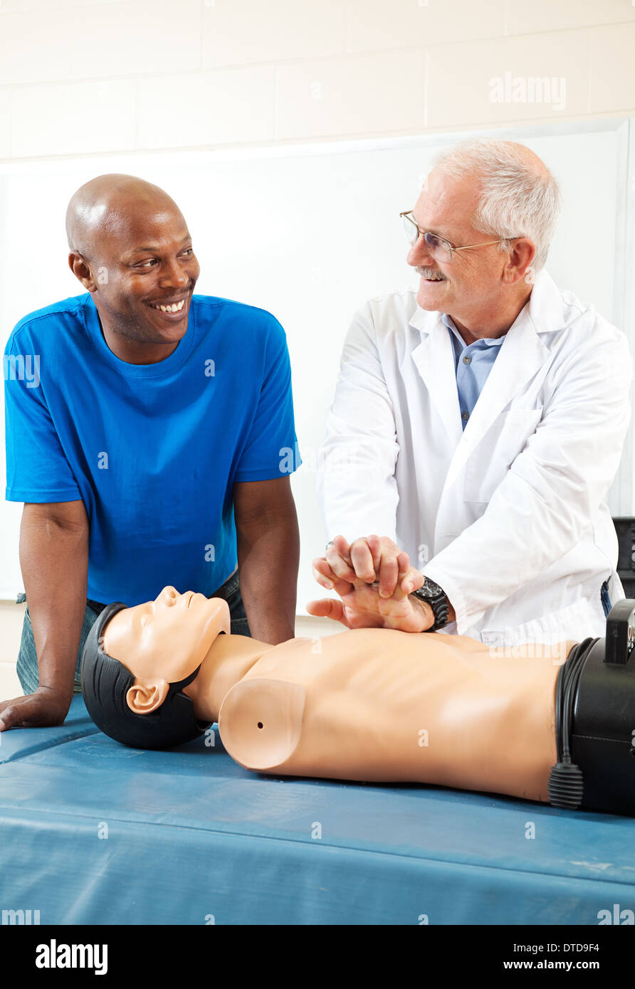 African-american adult student learning first aid CPR from a doctor. Stock Photo