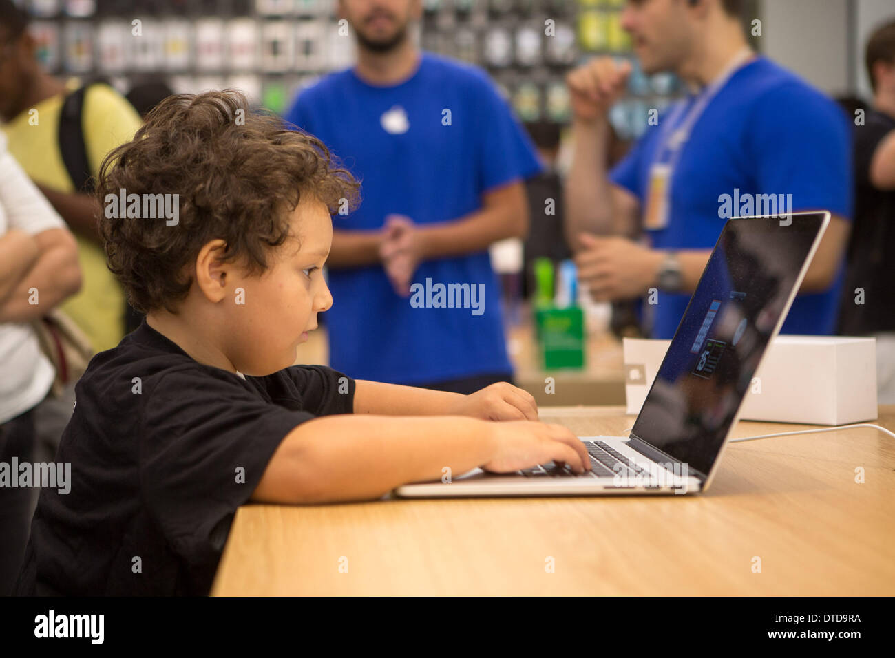 Rio De Janeiro, Brazil. 15th Feb, 2014. A young boy trys a macbook ...