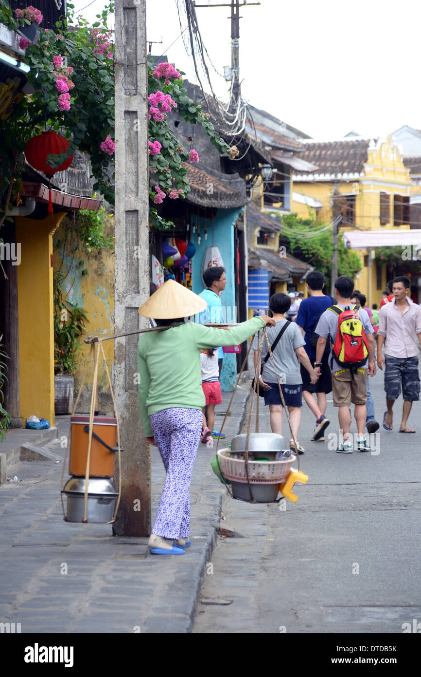 Vietnamese Street Hawker at Hoi An with Non La Hat Stock Photo
