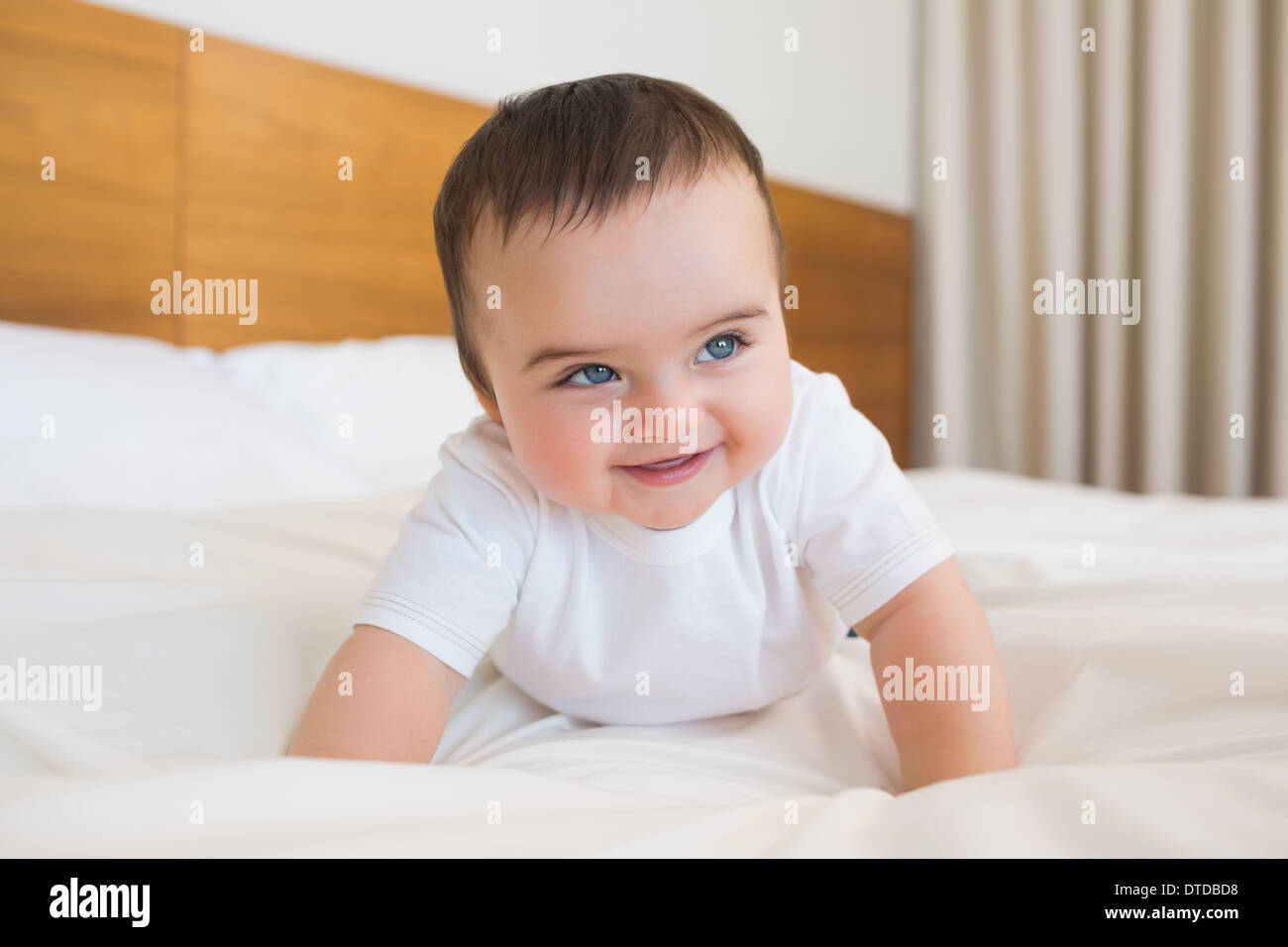 Happy baby boy in bed Stock Photo