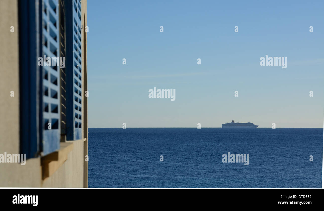 Passenger ferry boat on horizon and blurry window shutters in the