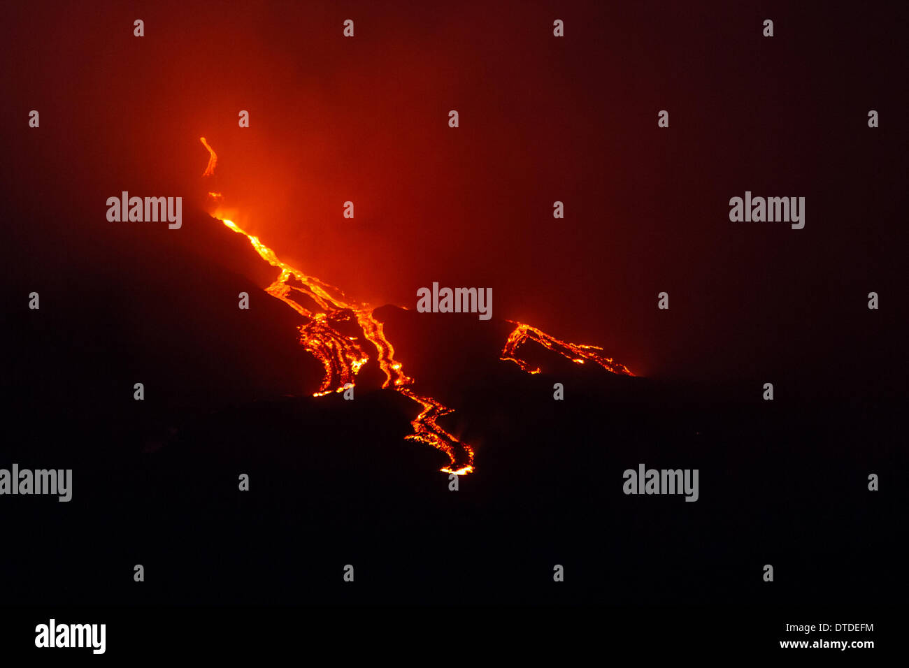 More explosions in the night and lava flow Stock Photo