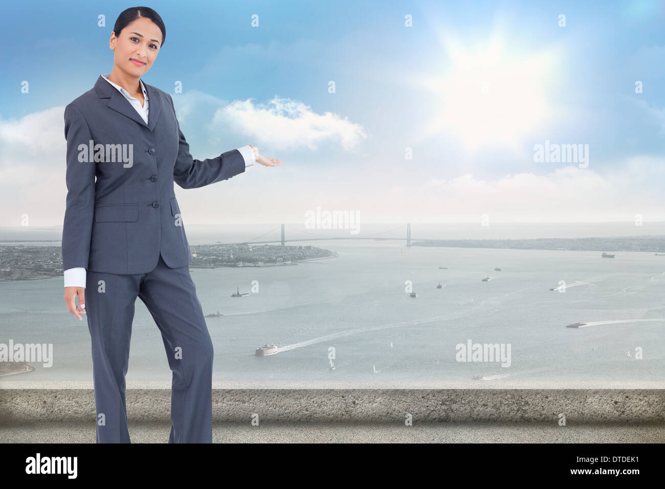 Composite image of standing businesswoman presenting Stock Photo