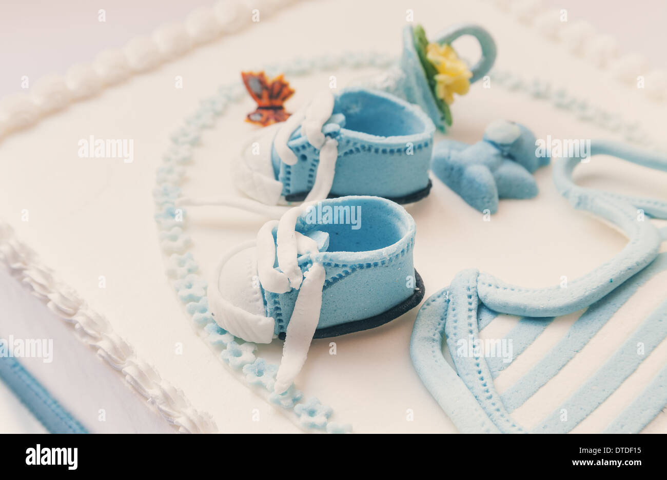 Birthday cake for baby, blue and white design, on light gray background