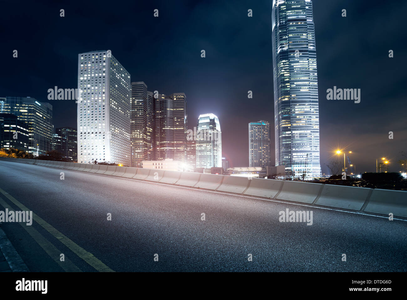 Highway and city at night Stock Photo - Alamy