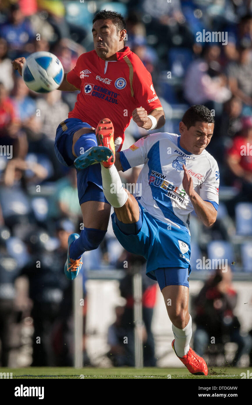 Mexico City, Mexico. 15th Feb, 2014. Marco Fabian (top) of Cruz Azul vies for the ball with Oscar Rojas of Puebla during the 2014 MX League Closing Tournament at Azul Stadium in Mexico City, capital of Mexico, on Feb. 15, 2014. Credit:  Pedro Mera/Xinhua/Alamy Live News Stock Photo