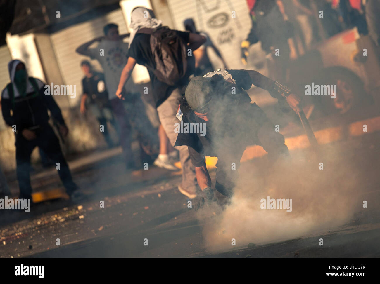 Caracas, Venezuela. 15th Feb, 2014. Students and riot police clash during a protest by government opponents, in the city of Caracas, capital of Venezuela, on Feb. 15, 2014. Credit:  Boris Vergara/Xinhua/Alamy Live News Stock Photo