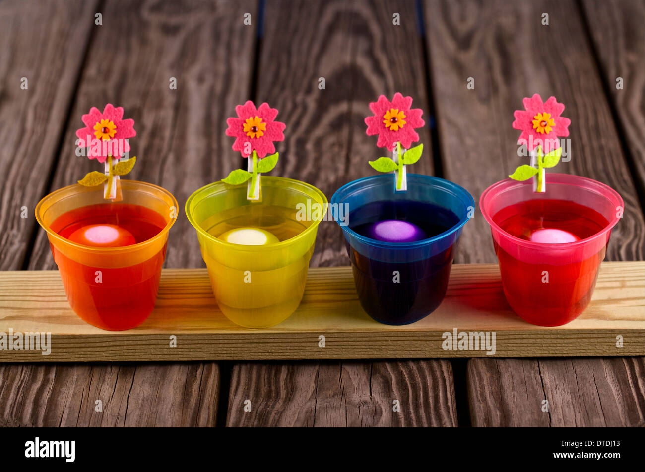 Easter eggs being dyed in several bowls Stock Photo