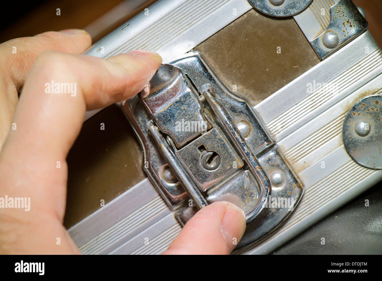 hand locking a rugged old case Stock Photo Alamy
