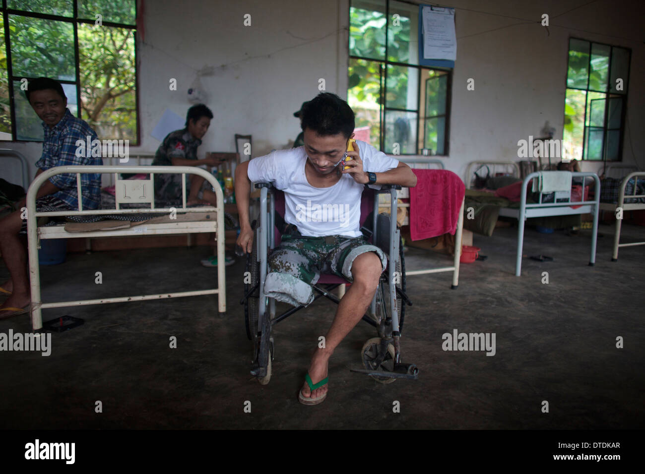 Kachin's militia member Lalaw Ze Dai, from Waimaw village, 25, talk on the phone with his girlfriend Stock Photo