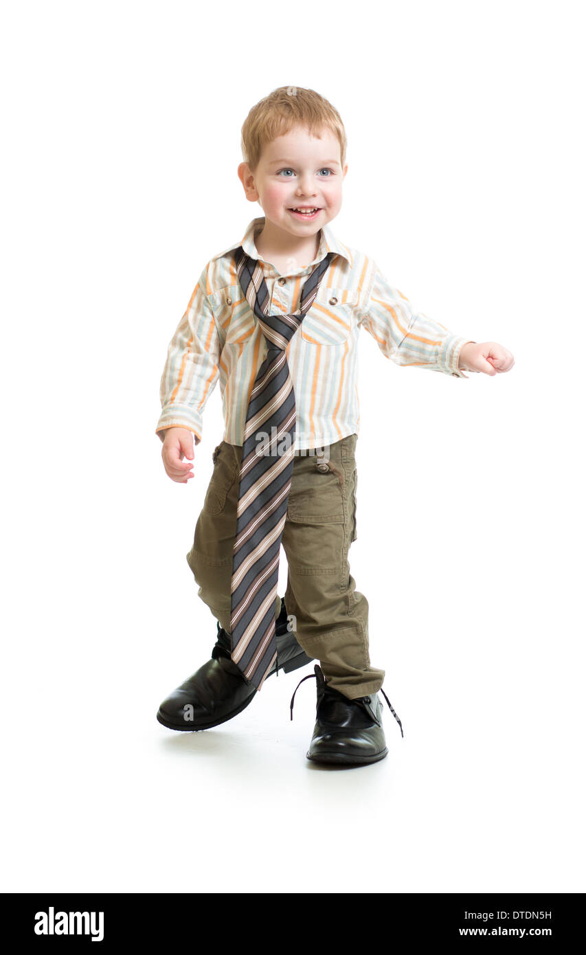 Adorable boy in big father's shoes isolated on white Stock Photo